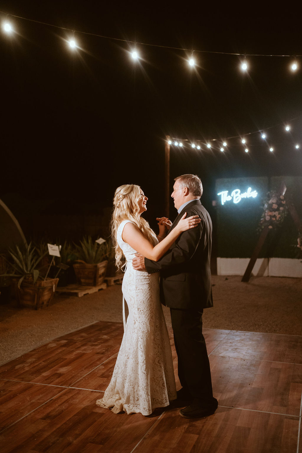 Bride Dancing with her Father under Bistro Lighting 