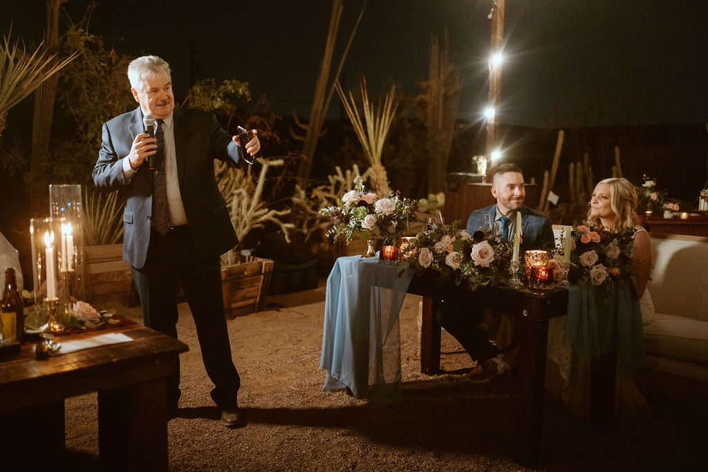 Man giving Speech while Couple at Sweetheart Table 