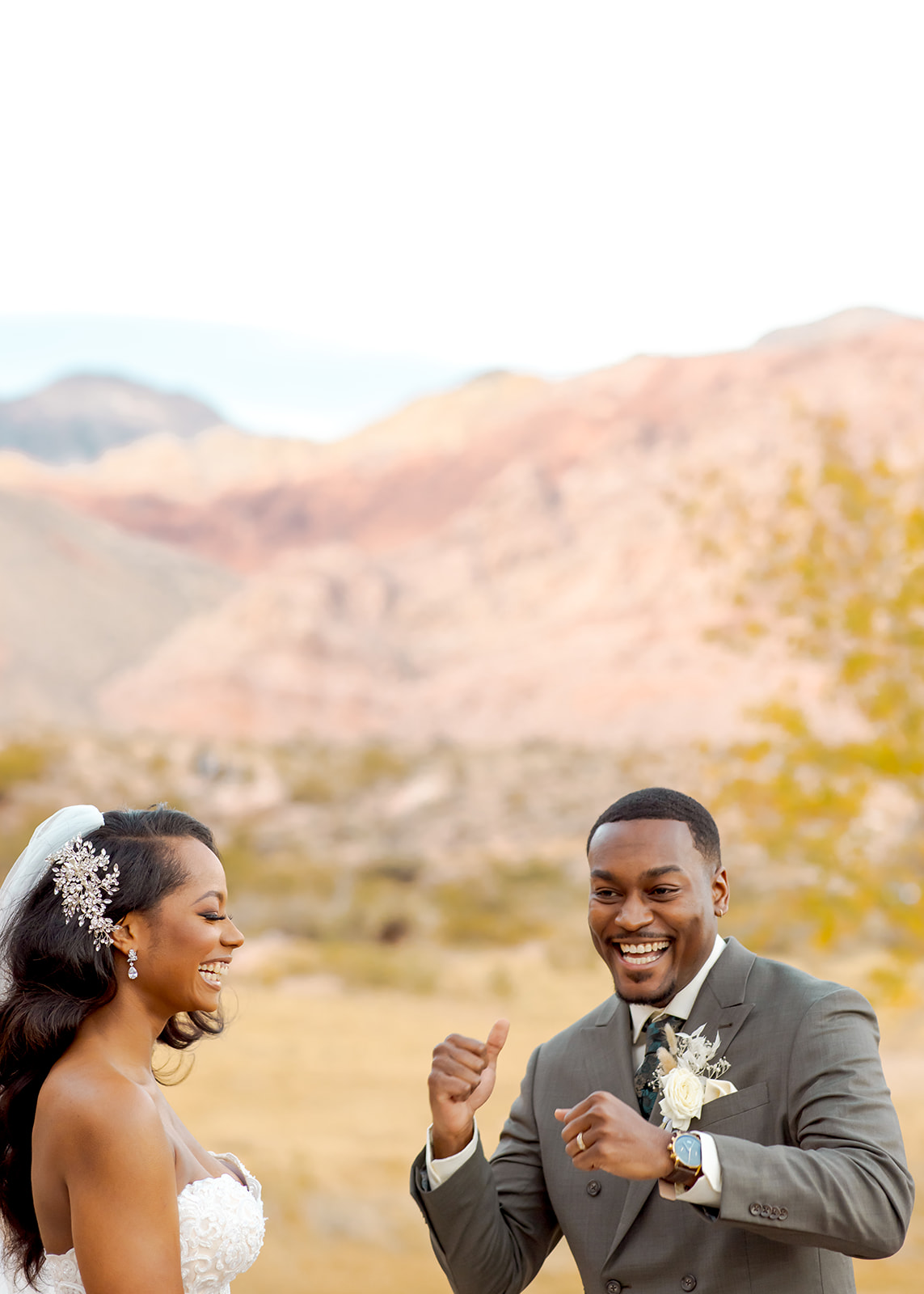 Groom celebrating and bride laughing after ring exchange 