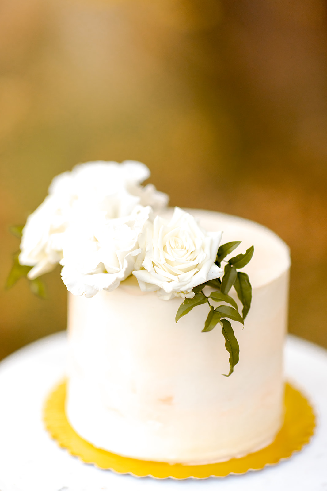 1 tier cake with white roses and greenery 