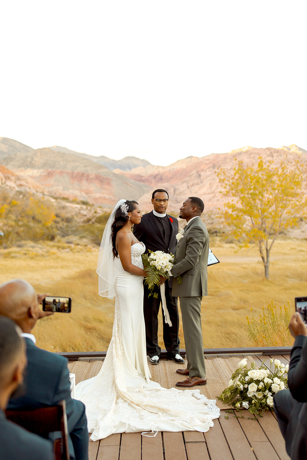 Couple getting married with yellow fall colors and mountains in the background at Red Rock Canyon in Las Vegas 