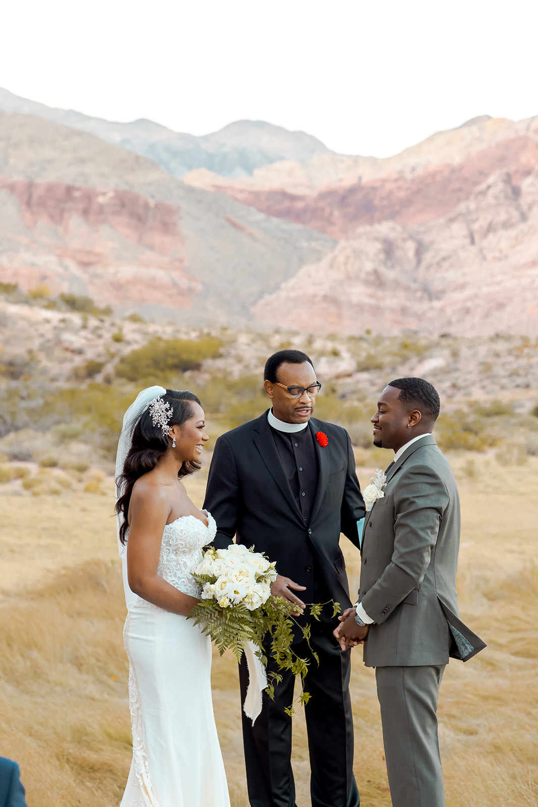Bride and groom getting married with dramatic Red Rock Canyon mountains in the back 
