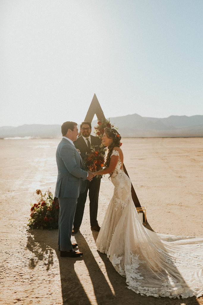 Bride & Groom Laughing under Triangle Arch will getting Married in Dry Lake Bed Fall Inspired Elopement 