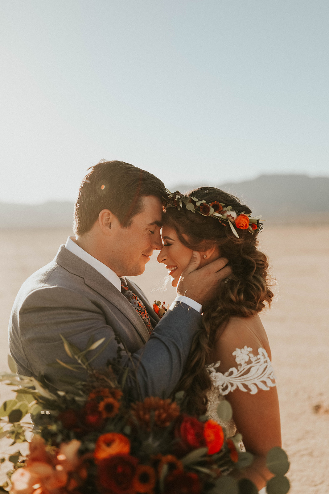 Groom Touching Brides Cheek and Posing Forehead to Forehead after Getting Eloped with Fall Inspired Bouquet 