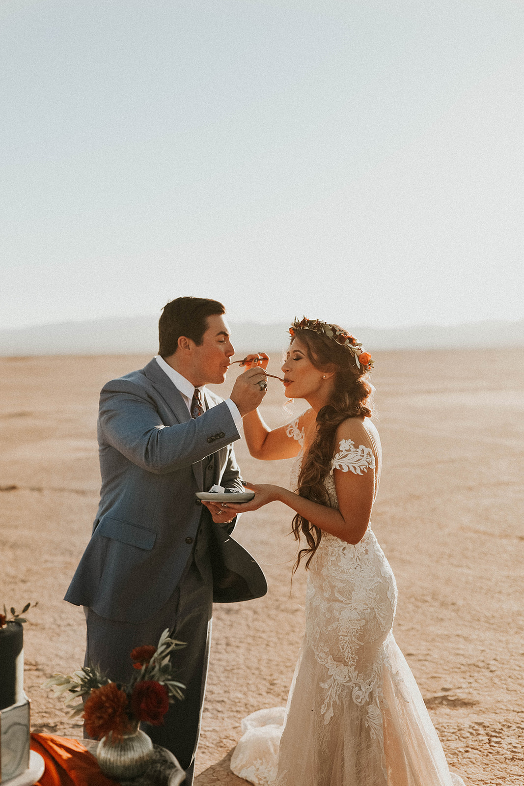 Couple giving each other Cake at Dry Lake Bed Fall Inspired Elopement 