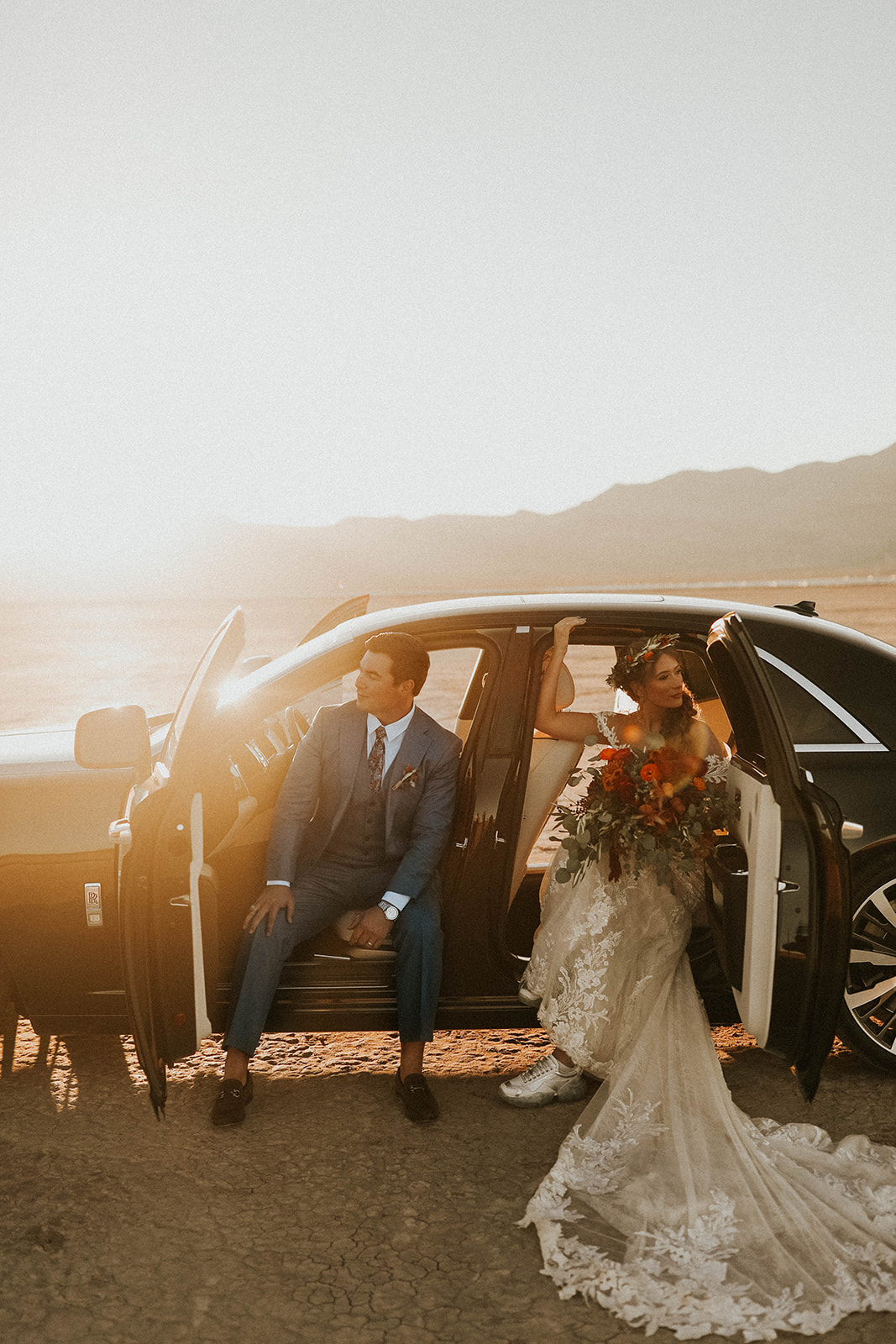 All Doors Open of Rolls Royce While Groom is in Front Seat & Bride is in the back during Dry Lake Bed Fall Inspired Elopement 