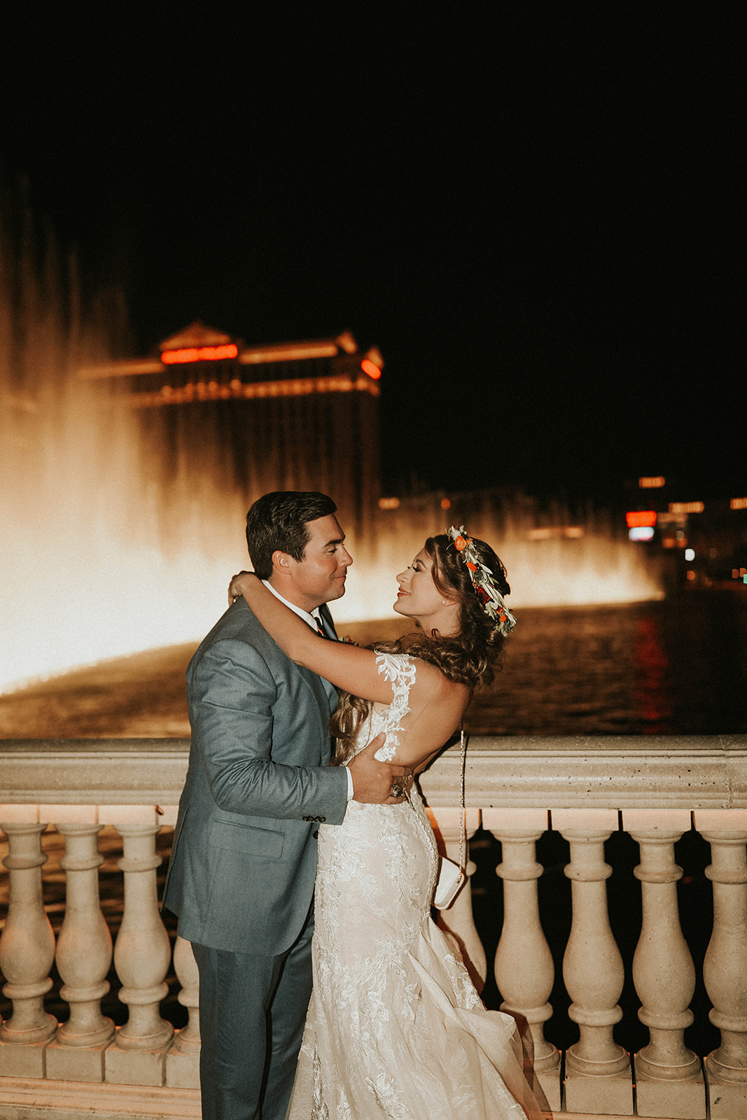 Newlyweds Looking at One Another at Bellagio Fountain after Dry Lake Bed Fall Inspired Elopement with Just the Two of Them 