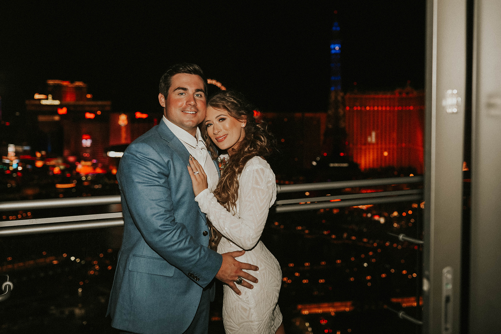 Couple on Balcony at The Cosmopolitan of Las Vegas after Bride Changed into Second Dress for Las Vegas Strip After Party with Friends