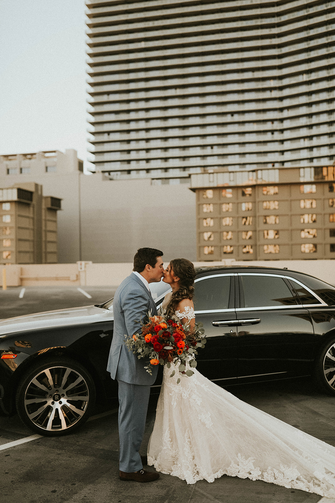 Bride & Groom Kissing in front of Rolls Royce during First Look 