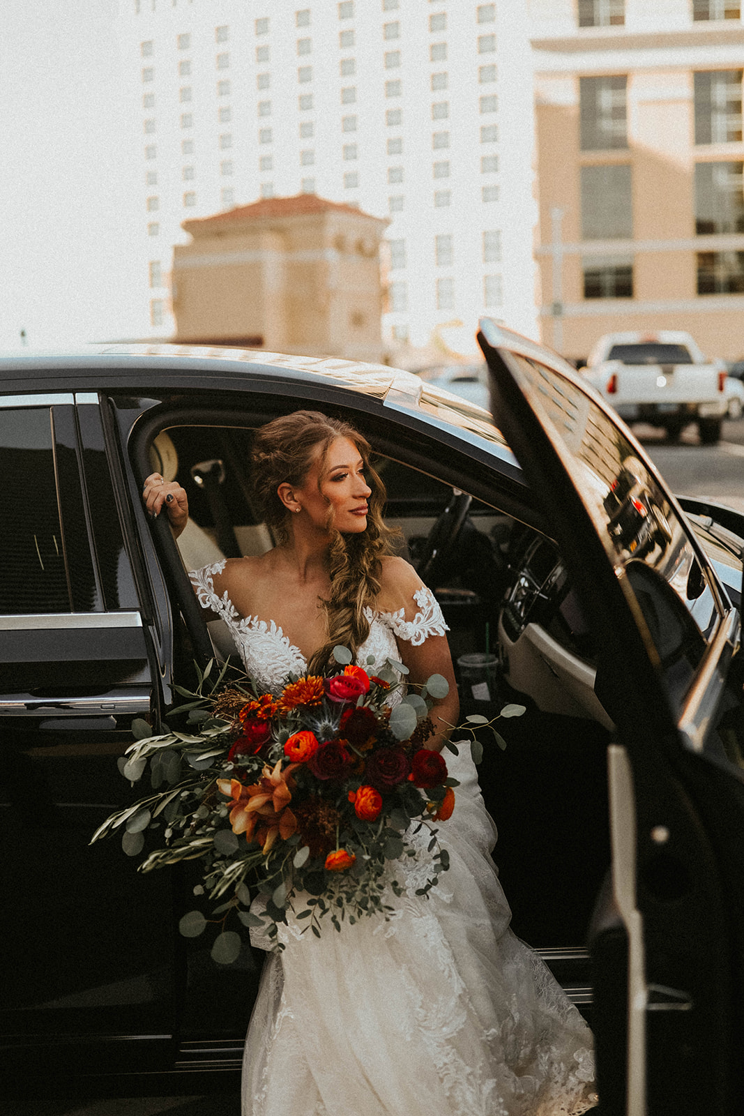 Bride holding Fall Inspired Bouquet While Sitting in Rolls Royce about to Leave for Elopement in Las Vegas 