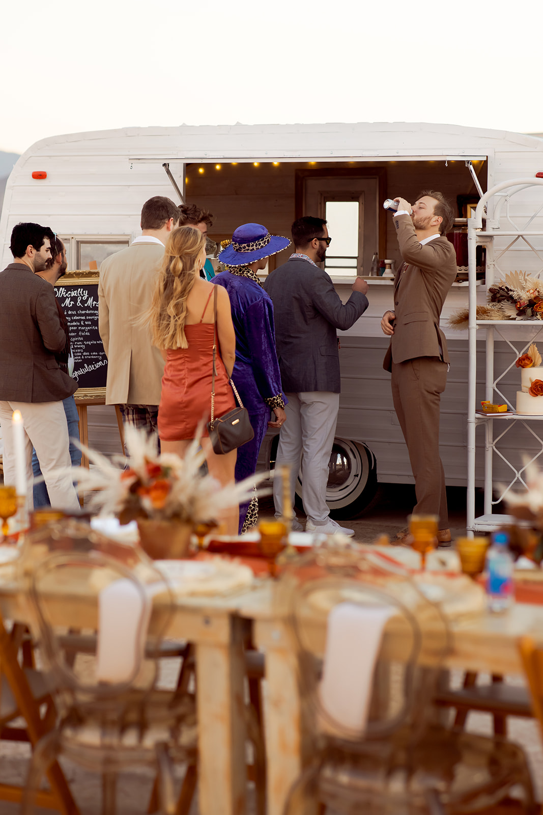 Guests getting drinks at mobile bar at Dry Lake Bed Micro-Wedding