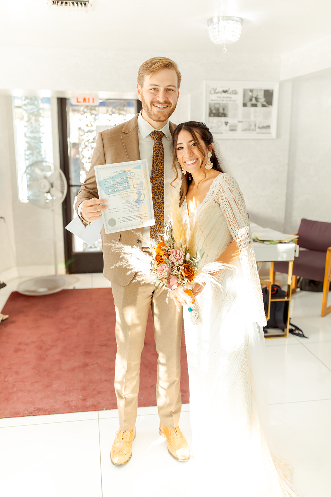Newlyweds holding marriage license after getting married in Las Vegas  