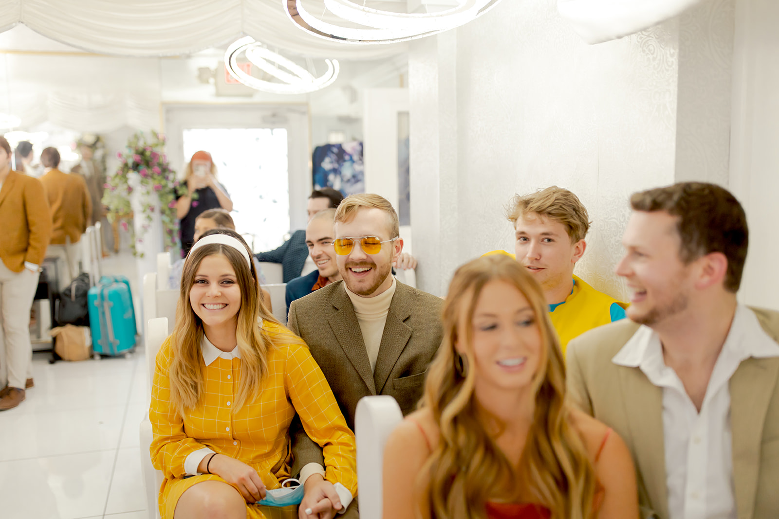 Guests in 70's attire waiting for ceremony to start in A Little White Wedding Chapel 