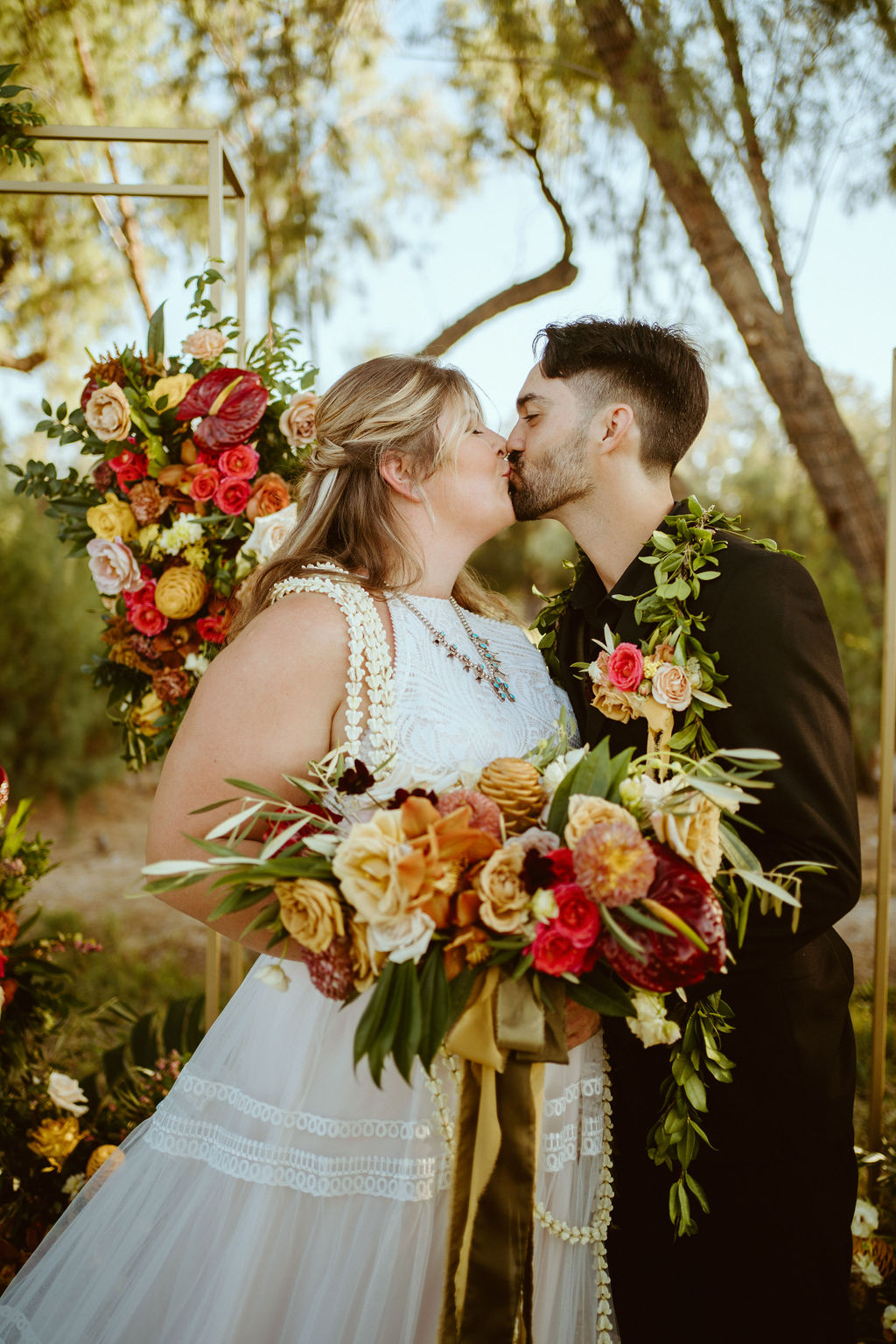 Newlyweds Kissing with Hawaiian Inspired Bouquet after GreenGale Farms Hawaiian Elopement