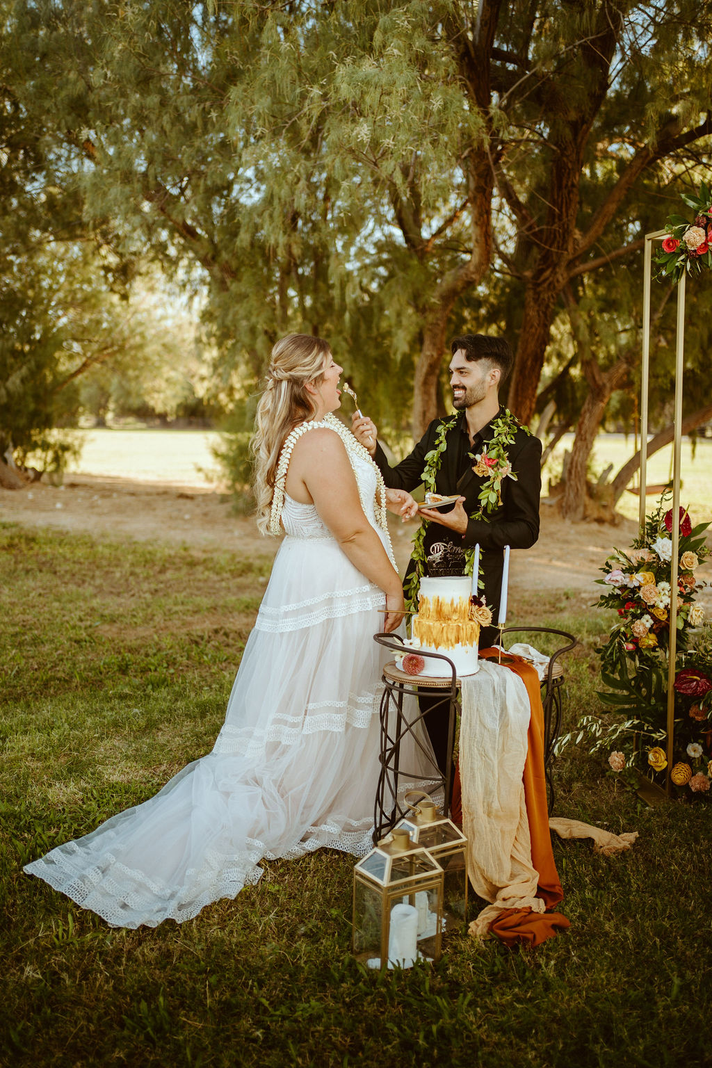 Newlyweds Enjoying Two-Tier Mustard Yellow and White Elopement Cake after GreenGale Farms Hawaiian Elopement