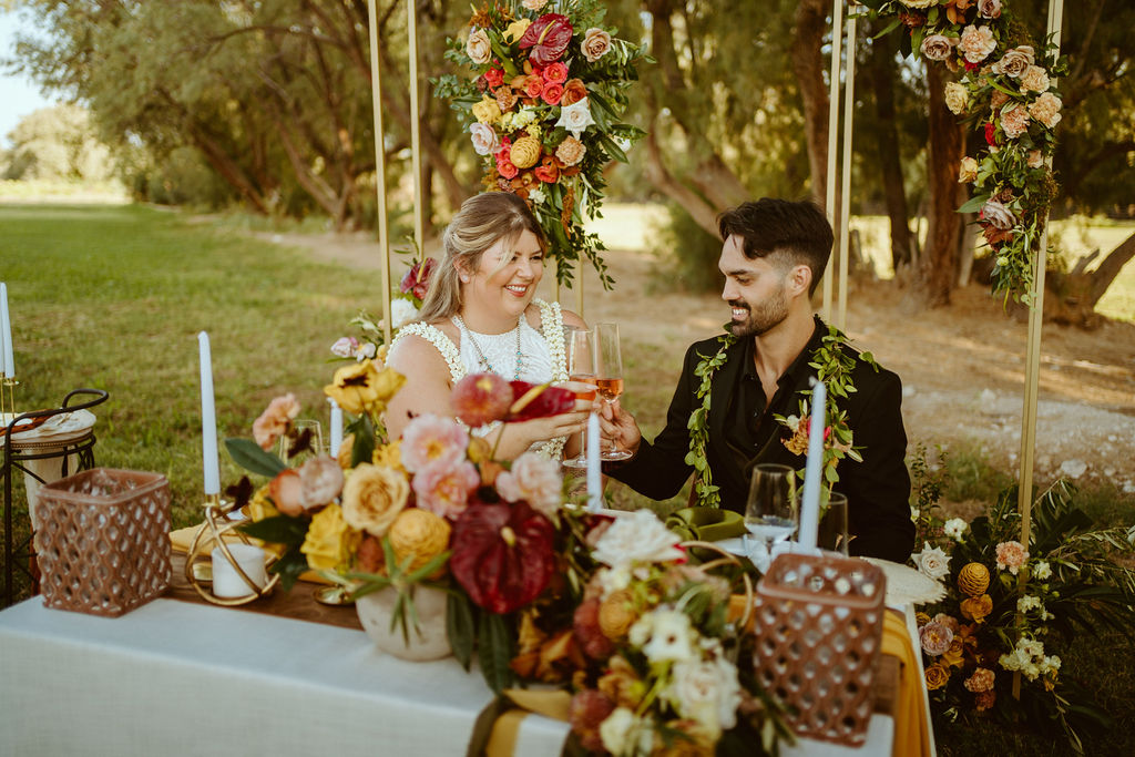Bride and Groom having Champagne at Sweetheart Table after GreenGale Farms Hawaiian Elopement