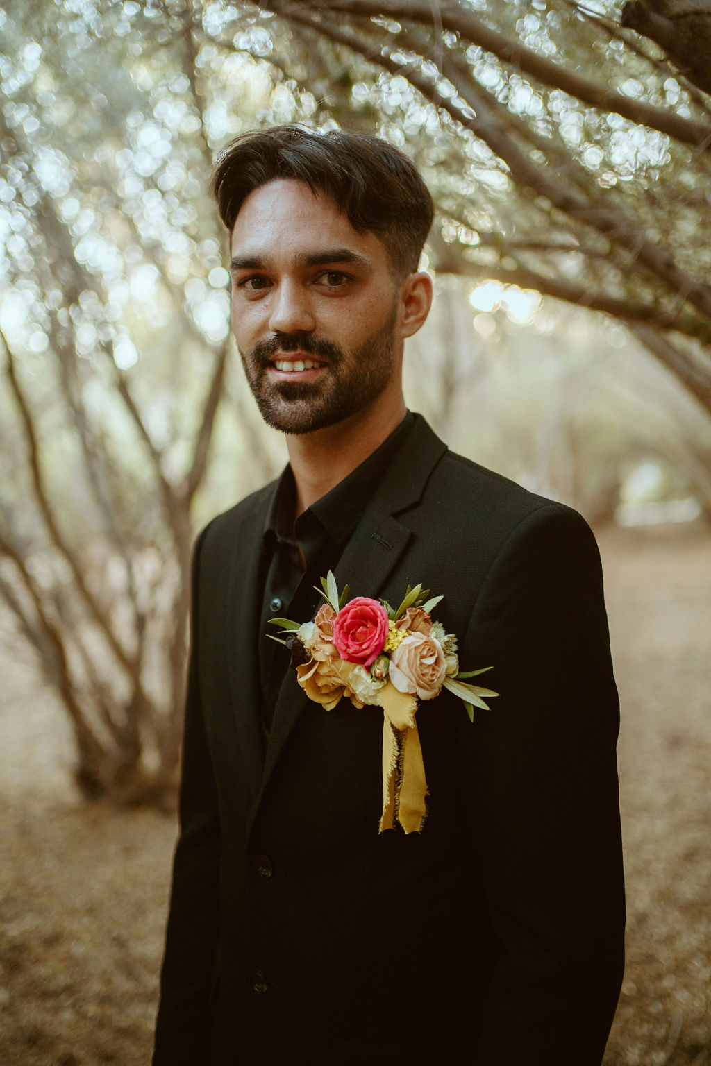 Groom in all Black Suit for GreenGale Farms Hawaiian Elopement 