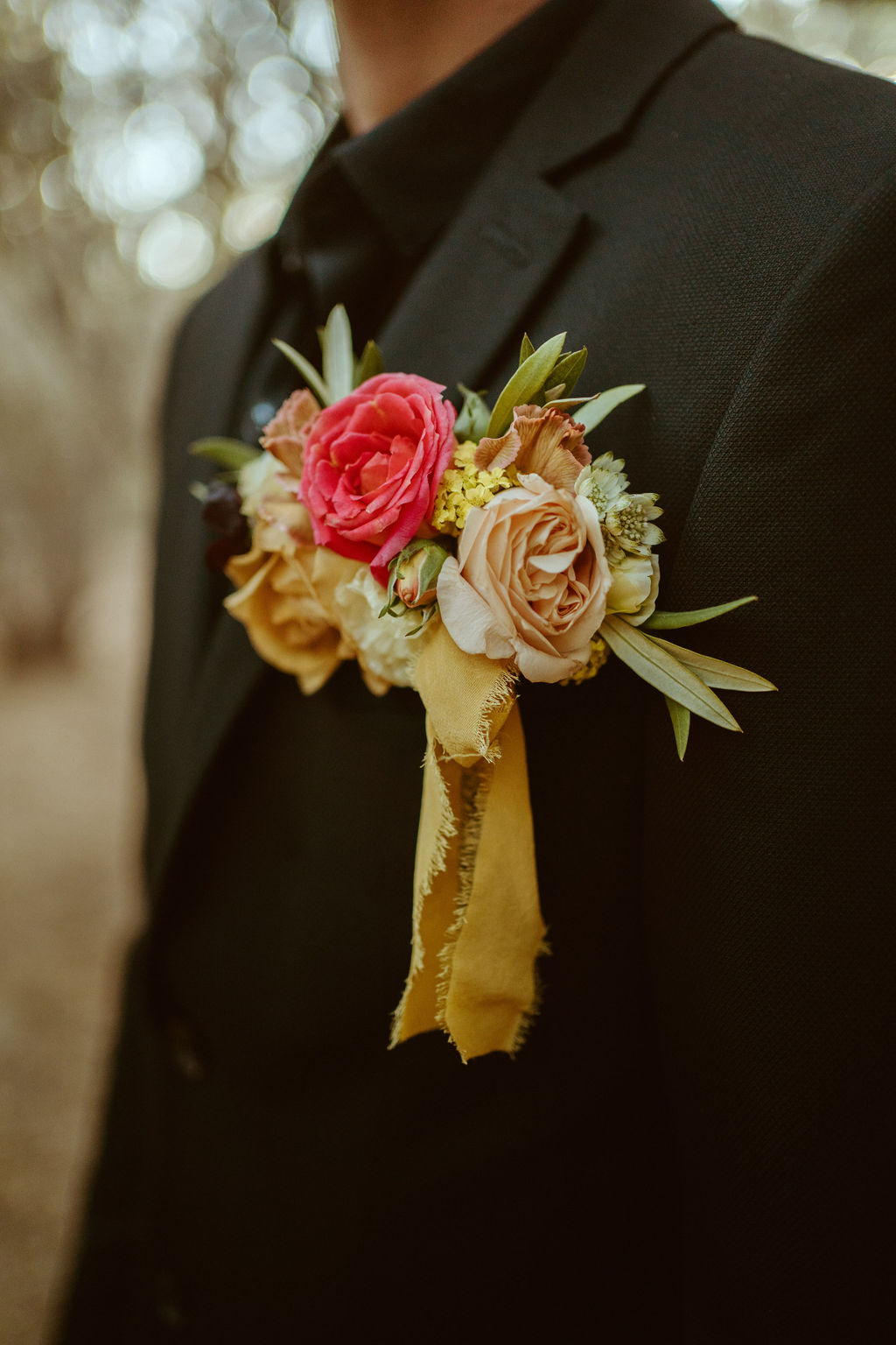 Groom's Boutonniere on all Black Suit in Olive Grove for GreenGale Farms Hawaiian Elopement 
