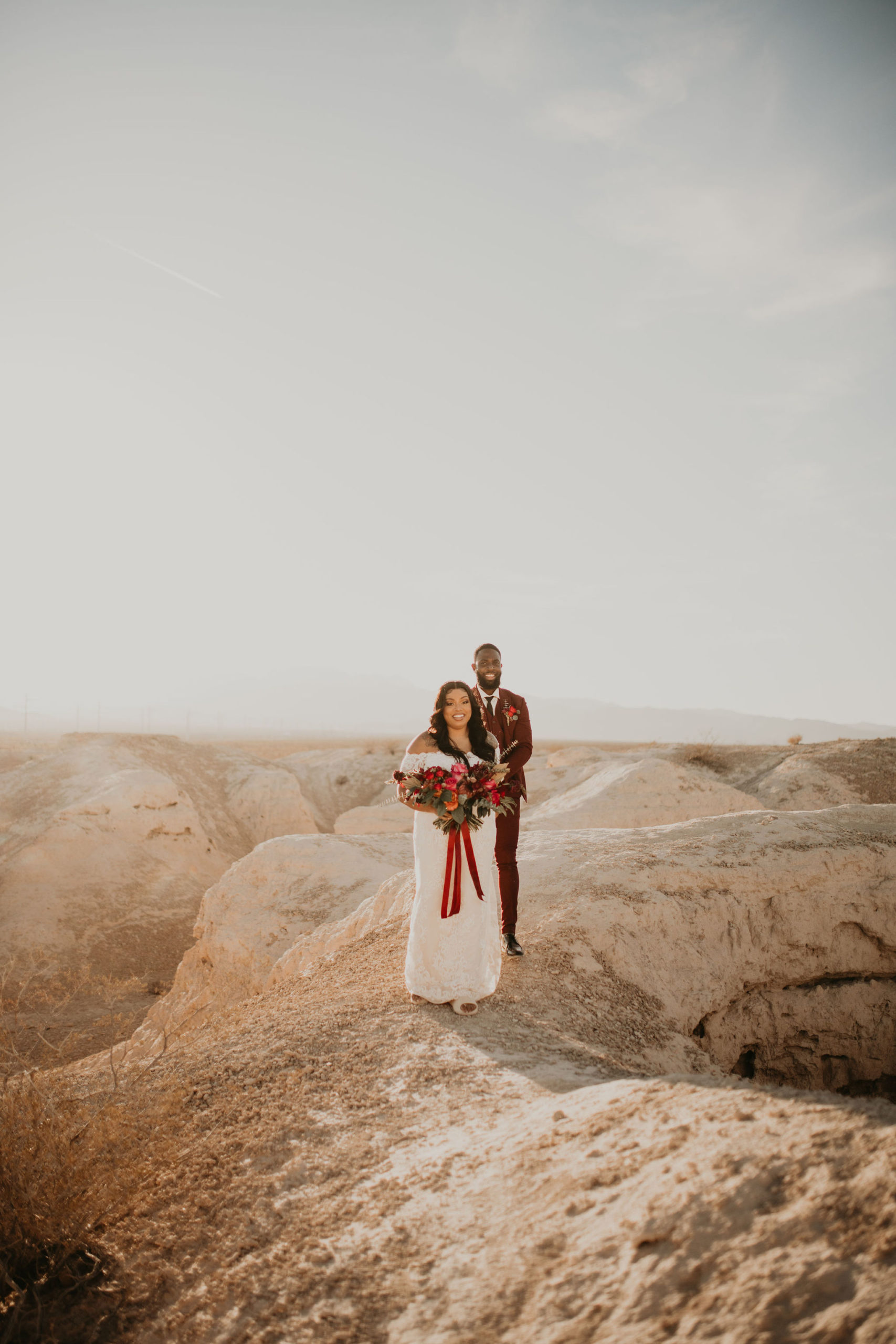 Bride and Groom Walking in Desert Together 