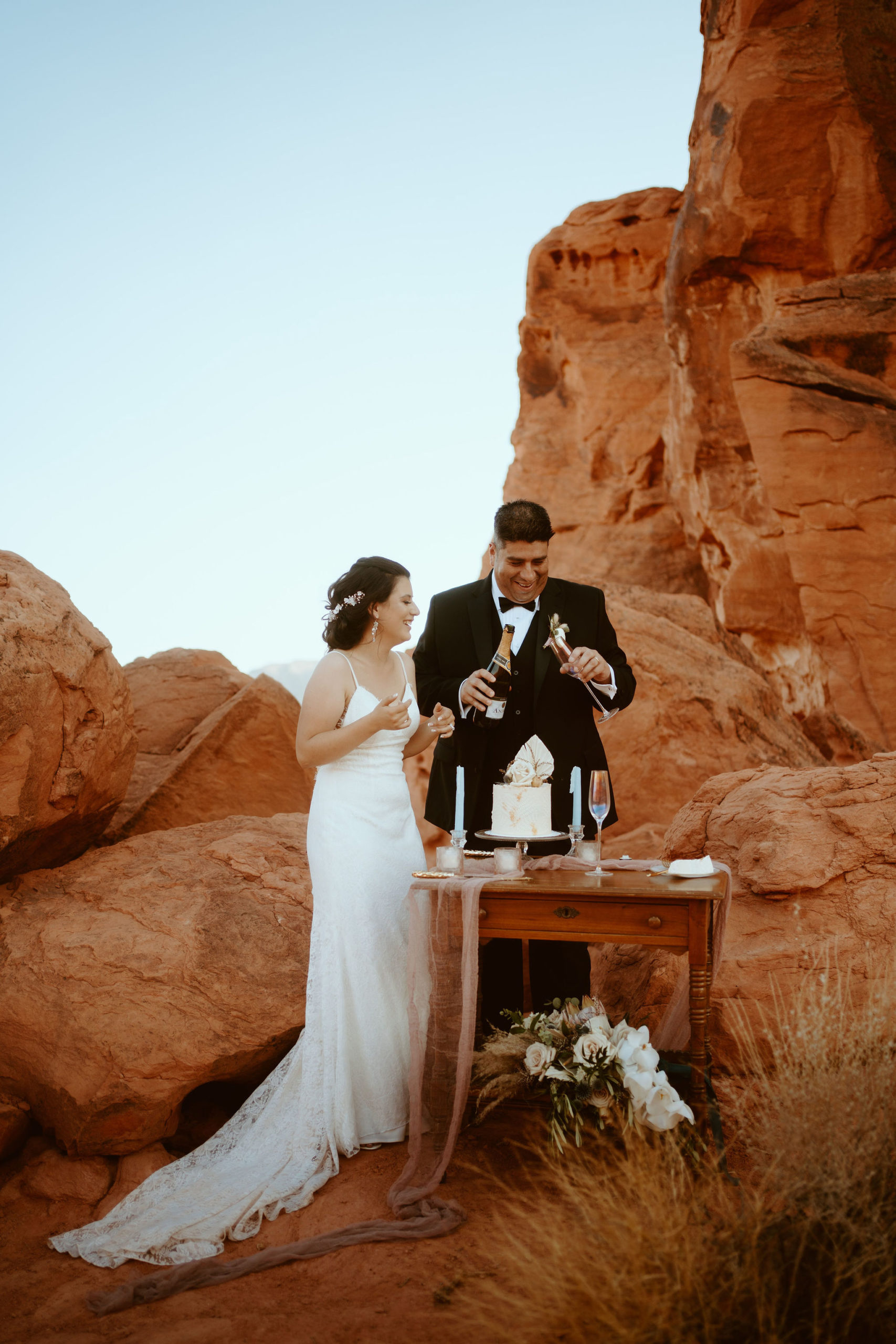 Groom Pouring Bride Champagne after Valley of Fire Ceremony 