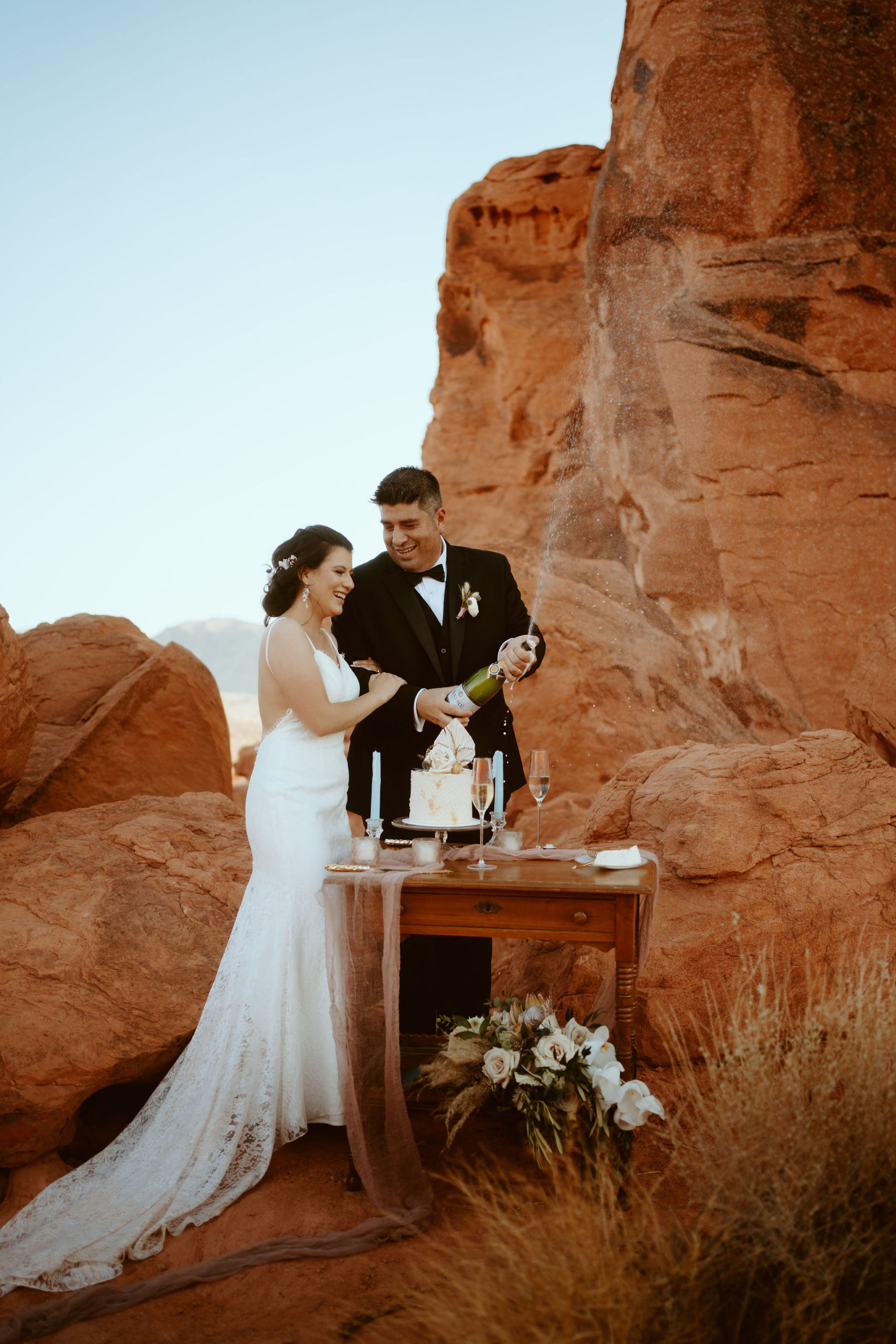 Newlyweds Laughing While Spraying Champagne after Just Outside of Las Vegas Elopement 