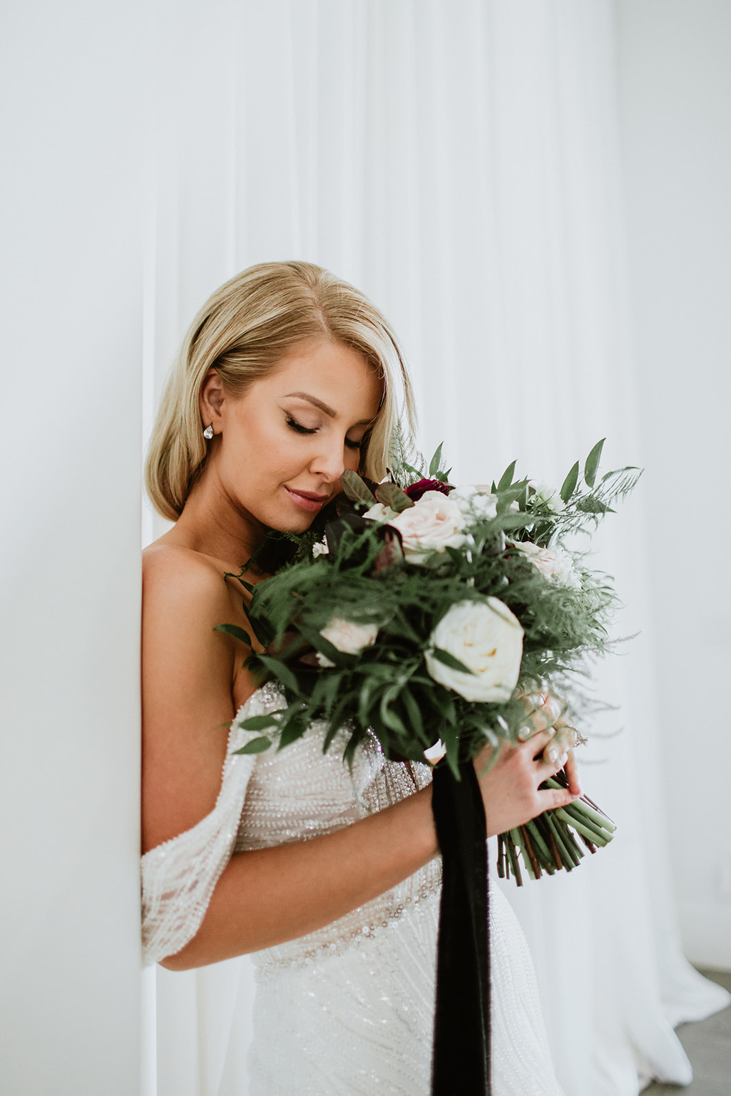 Bride holding Round Natural Modern & Moody Bouquet with black bouquet linen 