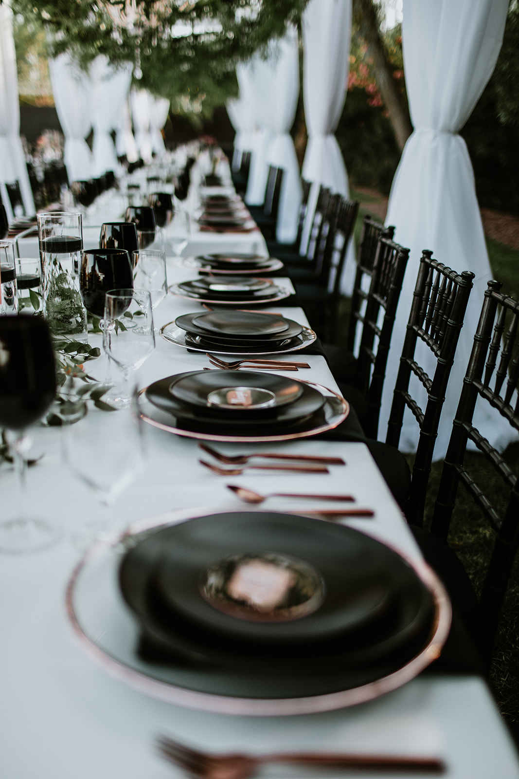 Place Setting with Black Wine Glasses and Black Chairs 