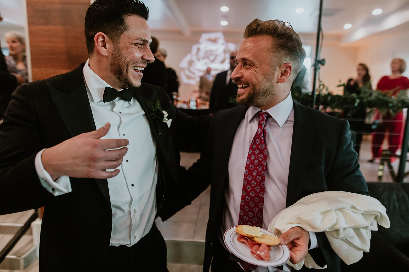 Groom Laughing with Guest during Cocktail hour 