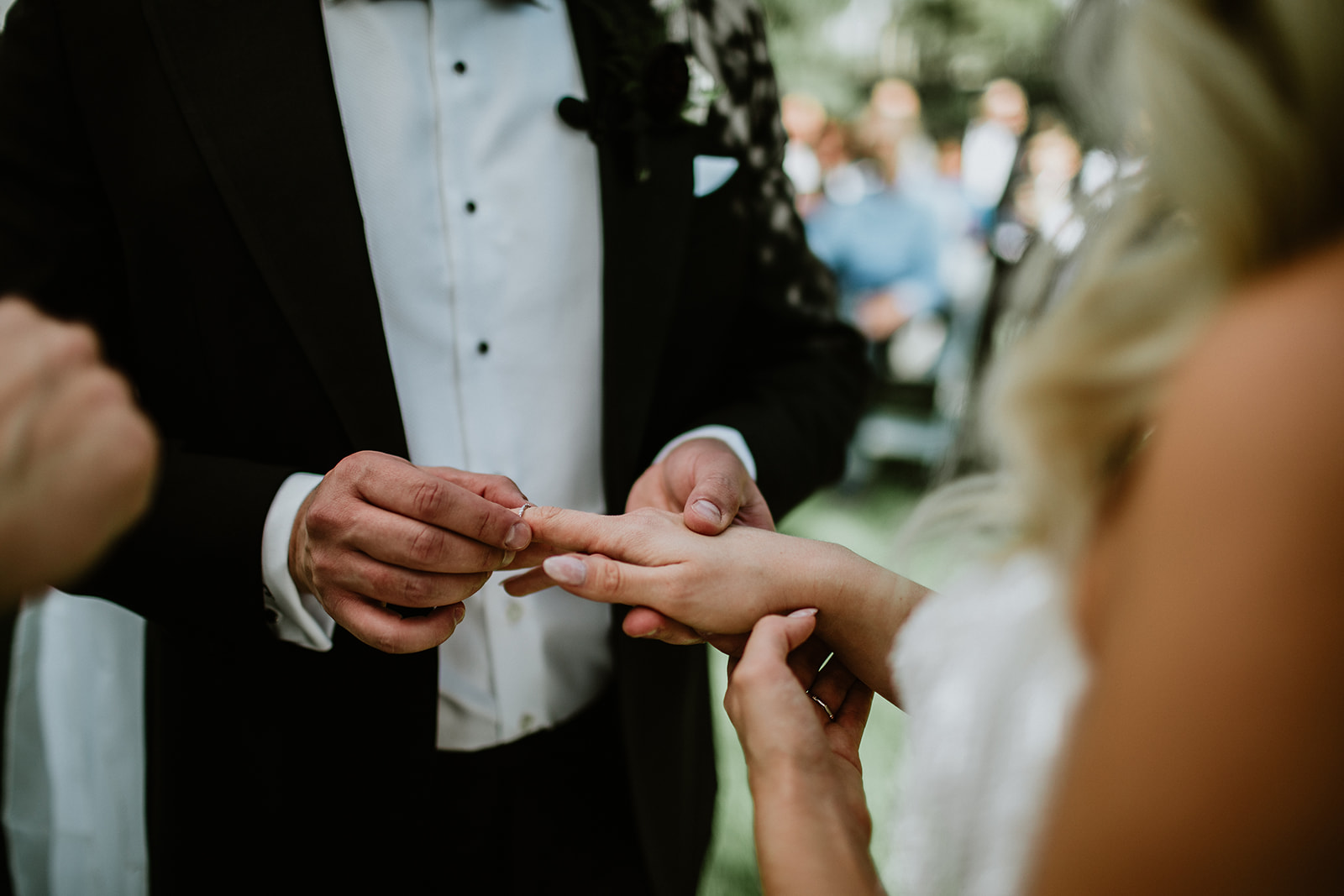 Groom putting Ring on Brides Finger 