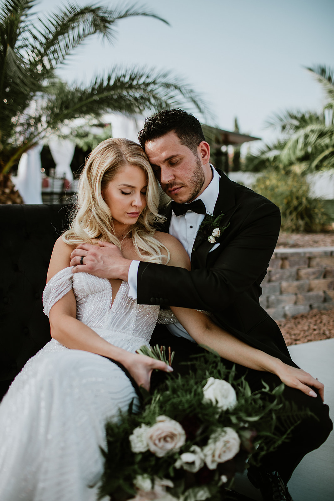 Newlyweds on black velvet couch at Lotus House in Las Vegas 