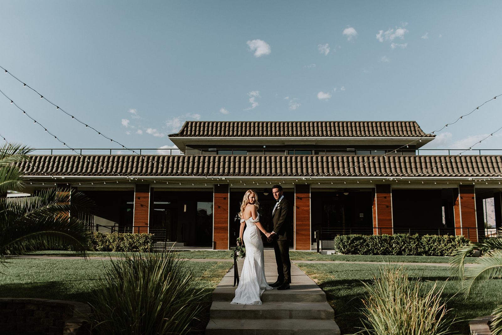 Newlyweds standing outside the Lotus House in Las Vegas for Moody Modern Glam Lotus House Wedding 
