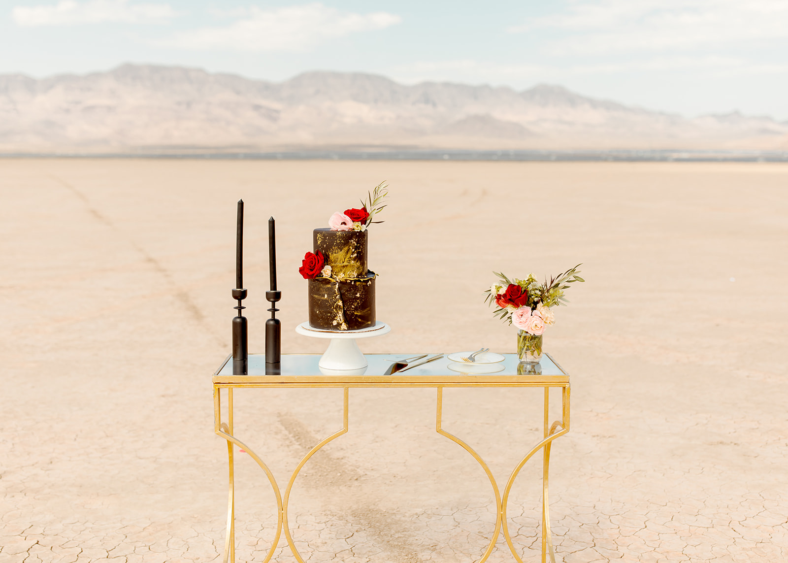 Moody Dry Lake Bed Elopement Cake Table with Black & Gold Two-Tier Cake & Black Taper Candles 