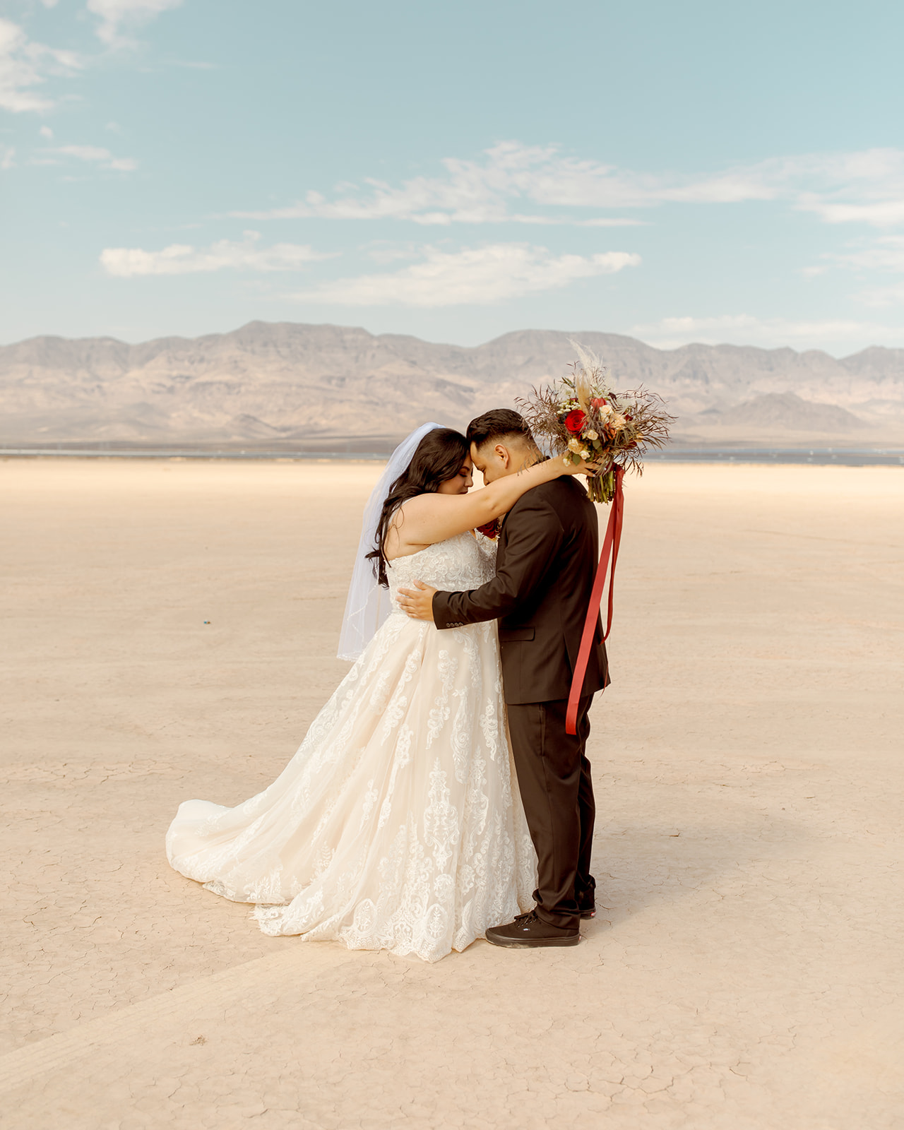 Couple Standing Forehead to Forehead after Moody Dry Lake Bed Elopement 