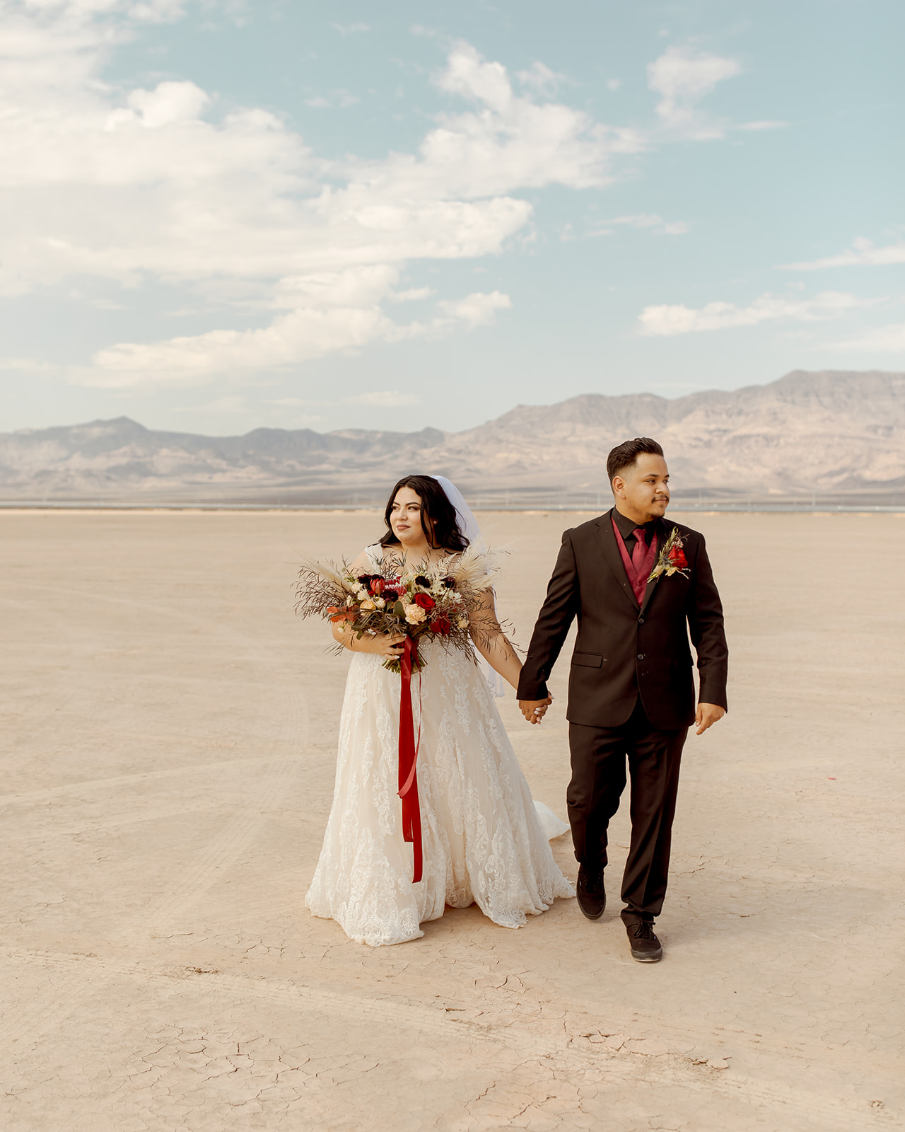 Newlyweds Walking on Dry Lake Bed after Eloping in Moody Dry Lake Bed Elopement 