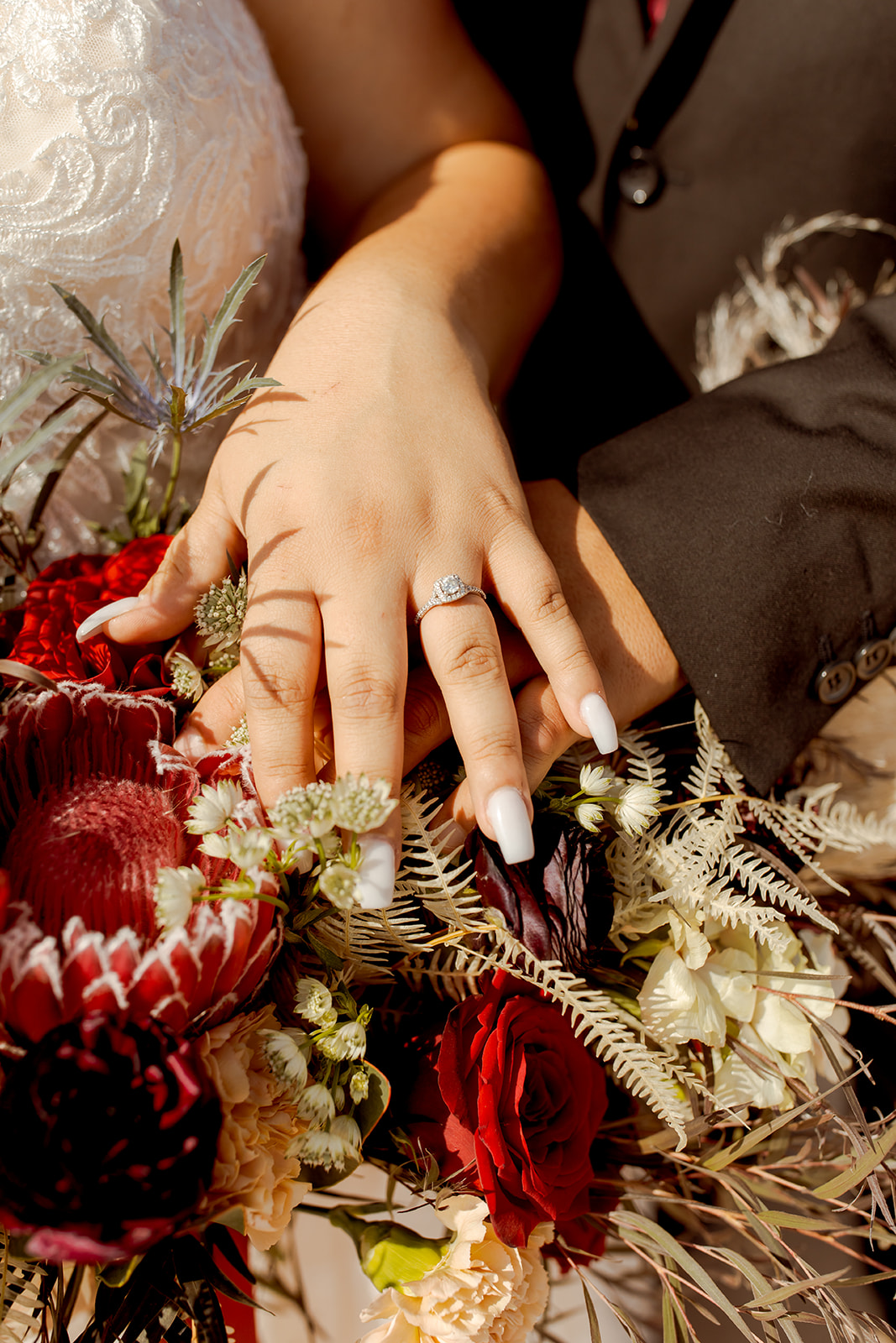 Bride's Hand with Wedding Ring Sitting on Bouquet 