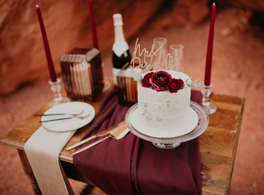 Designed Elopement Cake Table with Taper Candles, Linen, and Cake Topper 