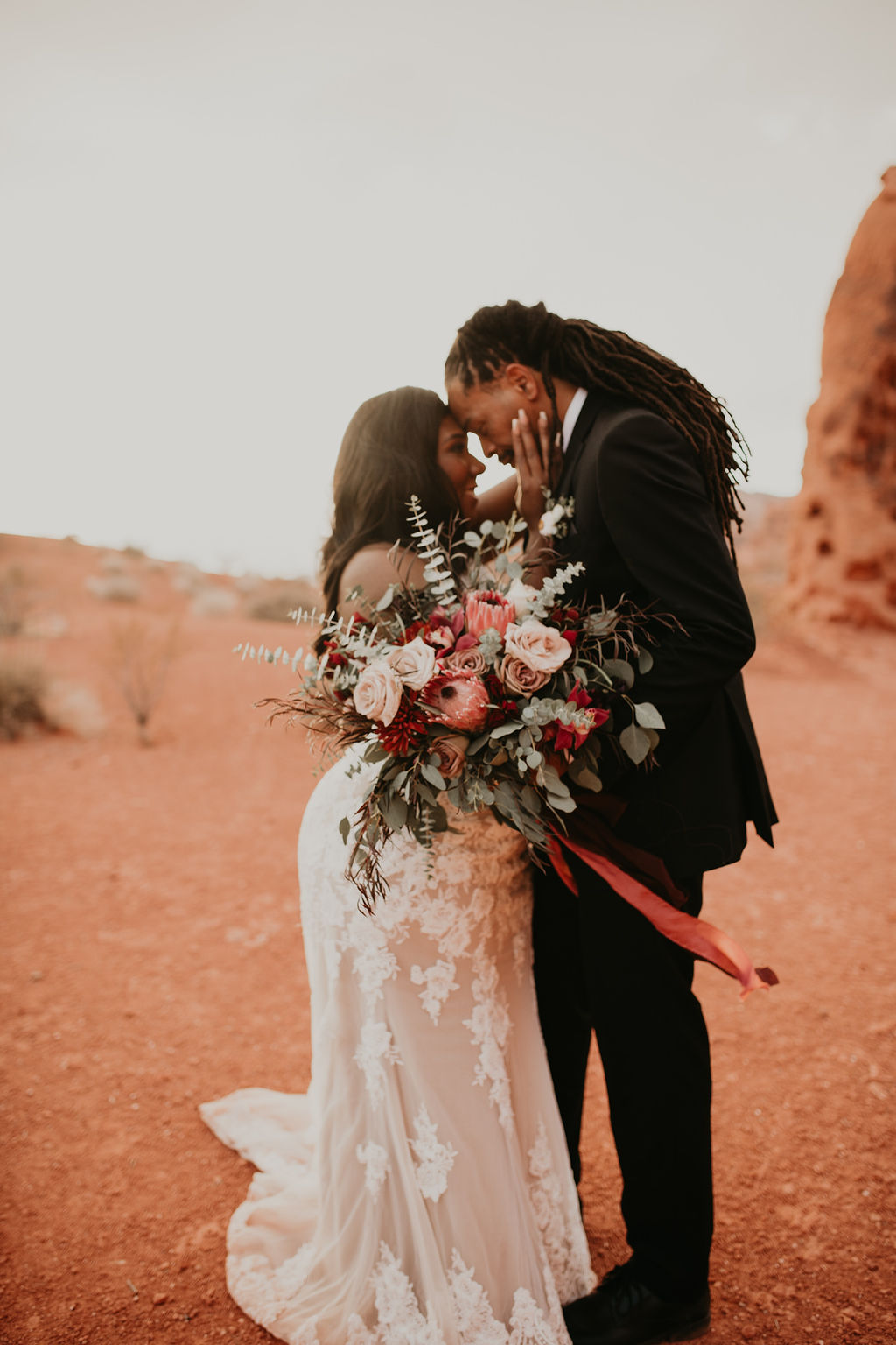 Bride and Groom at Valley of Fire Rustic Pink Burgundy and Sage Elopement 