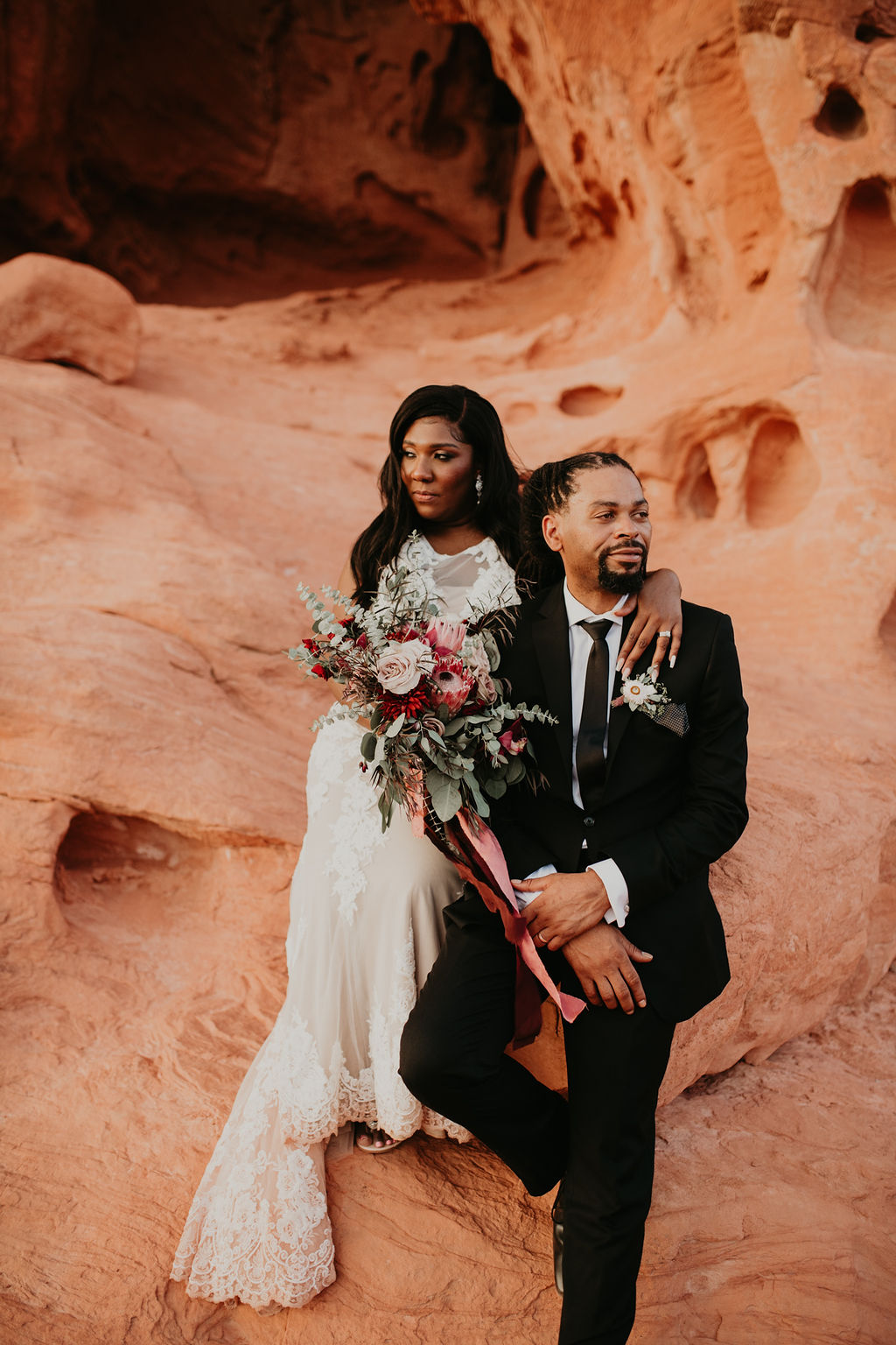 Bride and Groom Sitting Together on Red Rocks outside of Las Vegas 