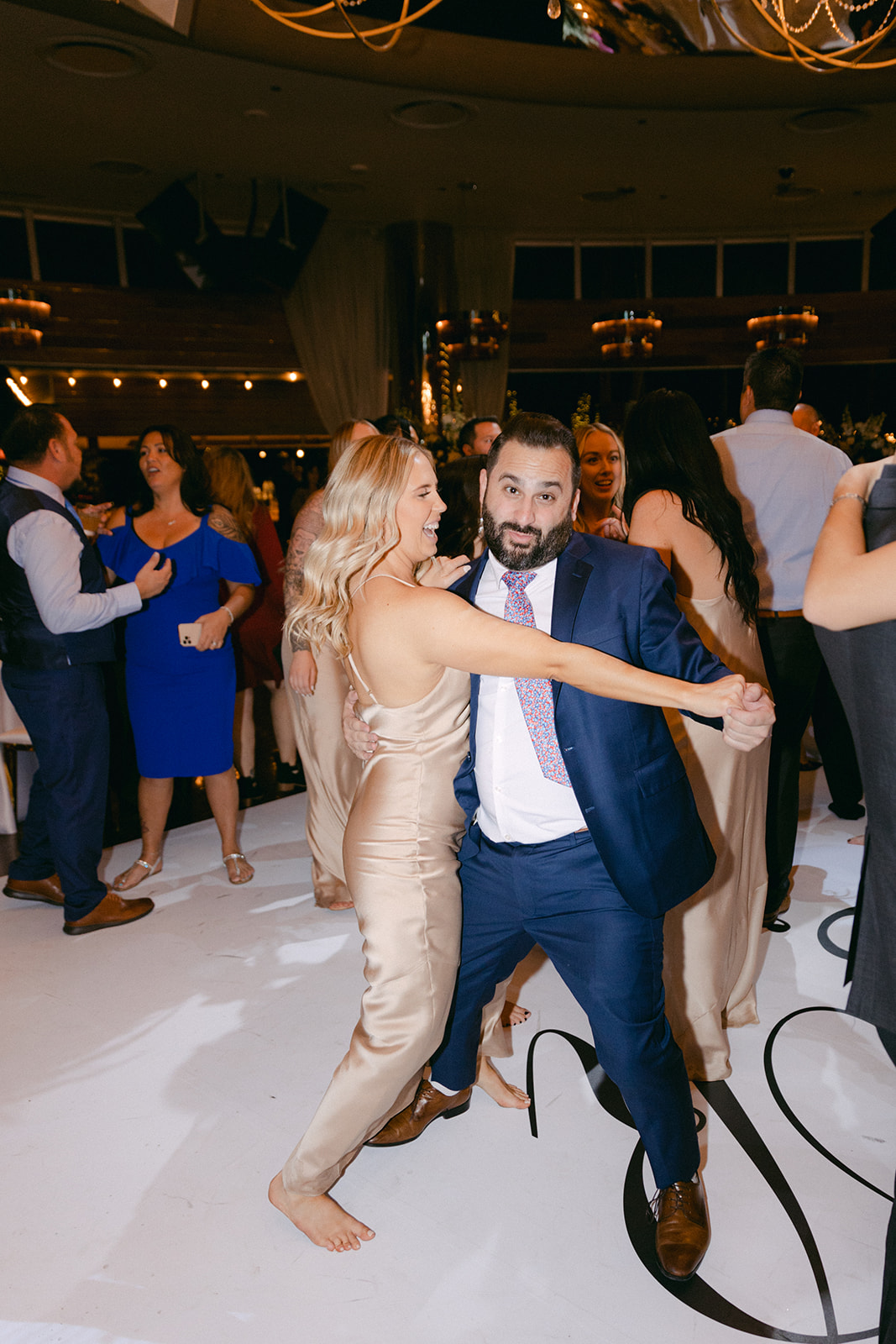 Bridesmaid and guest dancing 