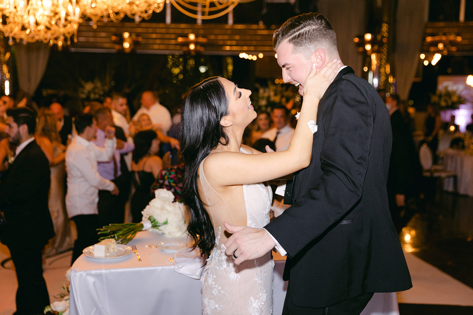 Newlyweds laughing during reception 