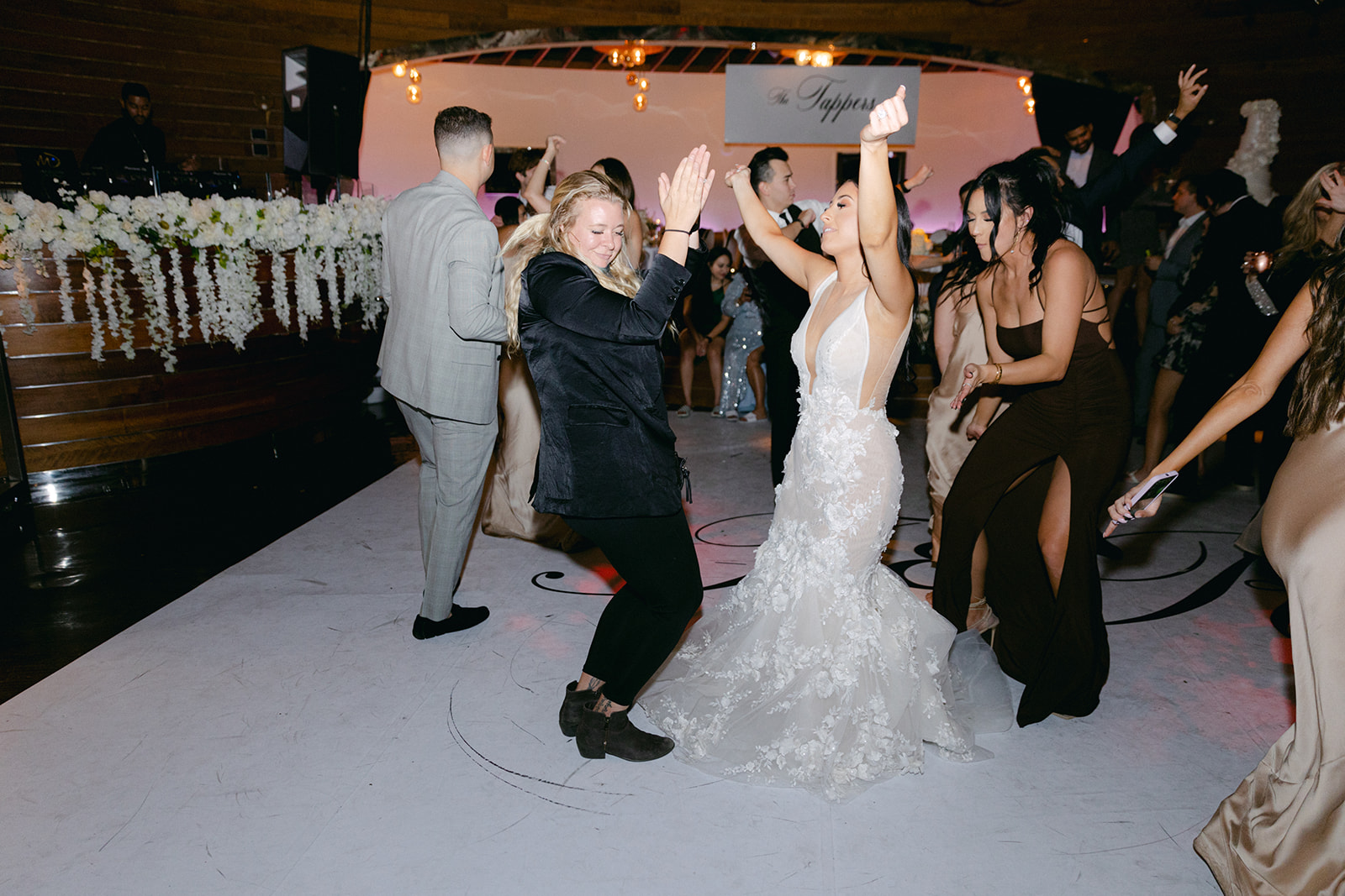 Bride dancing with wedding planner during reception 