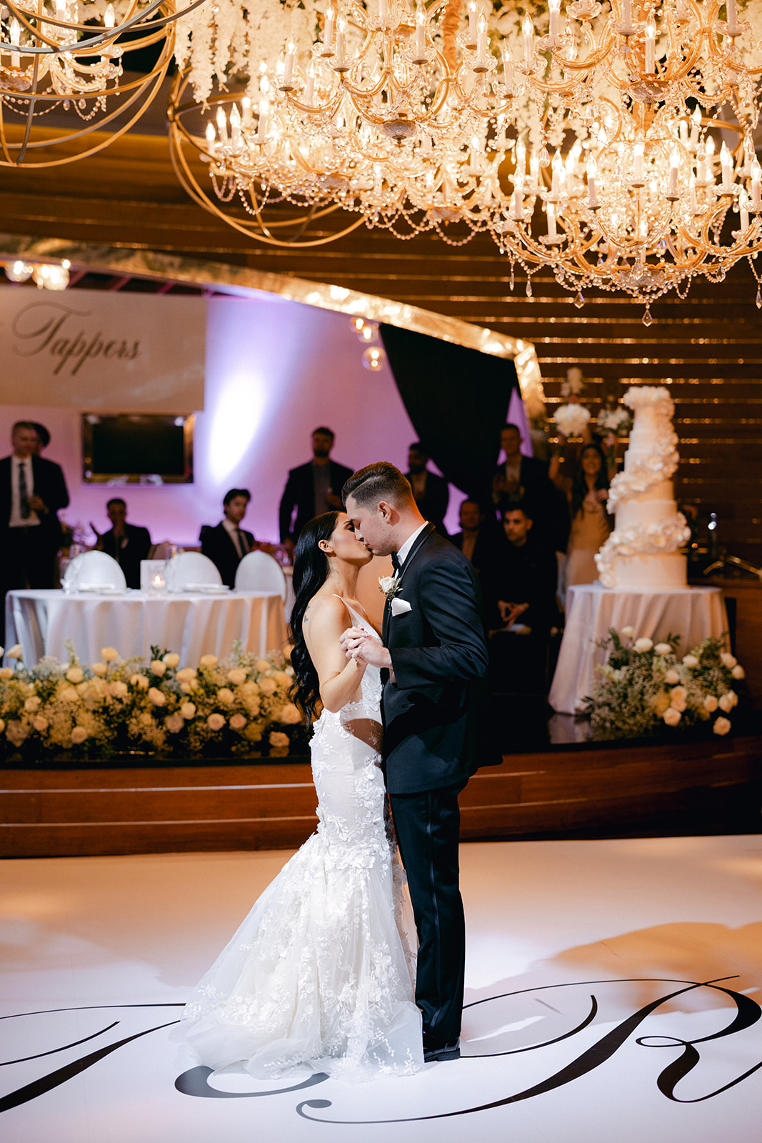 Newlyweds kissing during first dance to start reception 