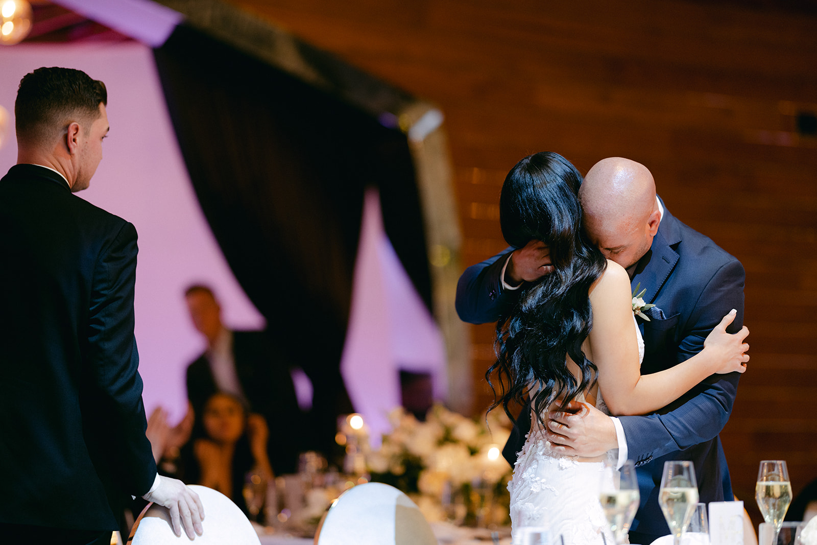 Father hugging bride after reception speech