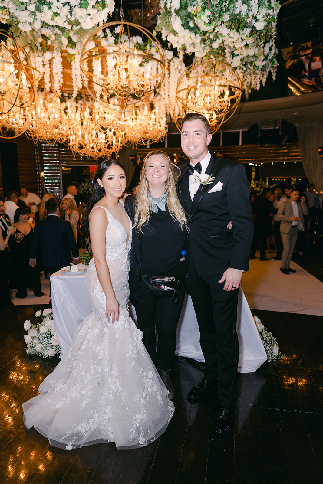 Bride and Groom with wedding planner during their reception 