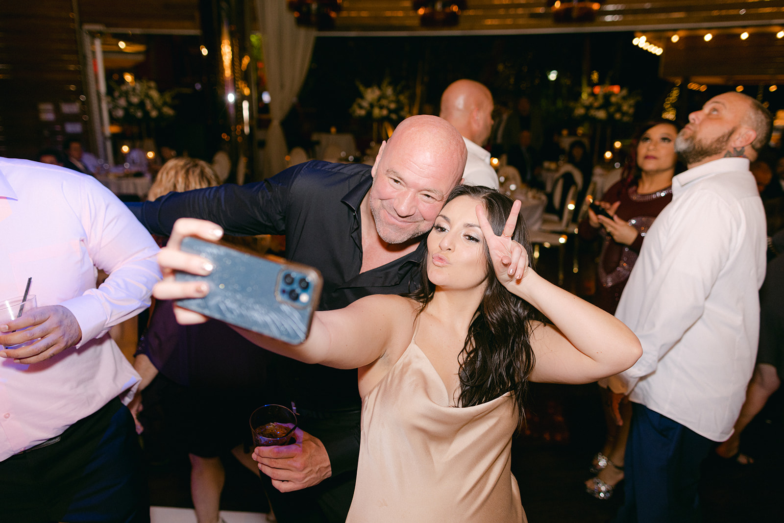 Bridesmaid posing with guest for selfie at Red Rock Casino Timeless Modern Wedding 