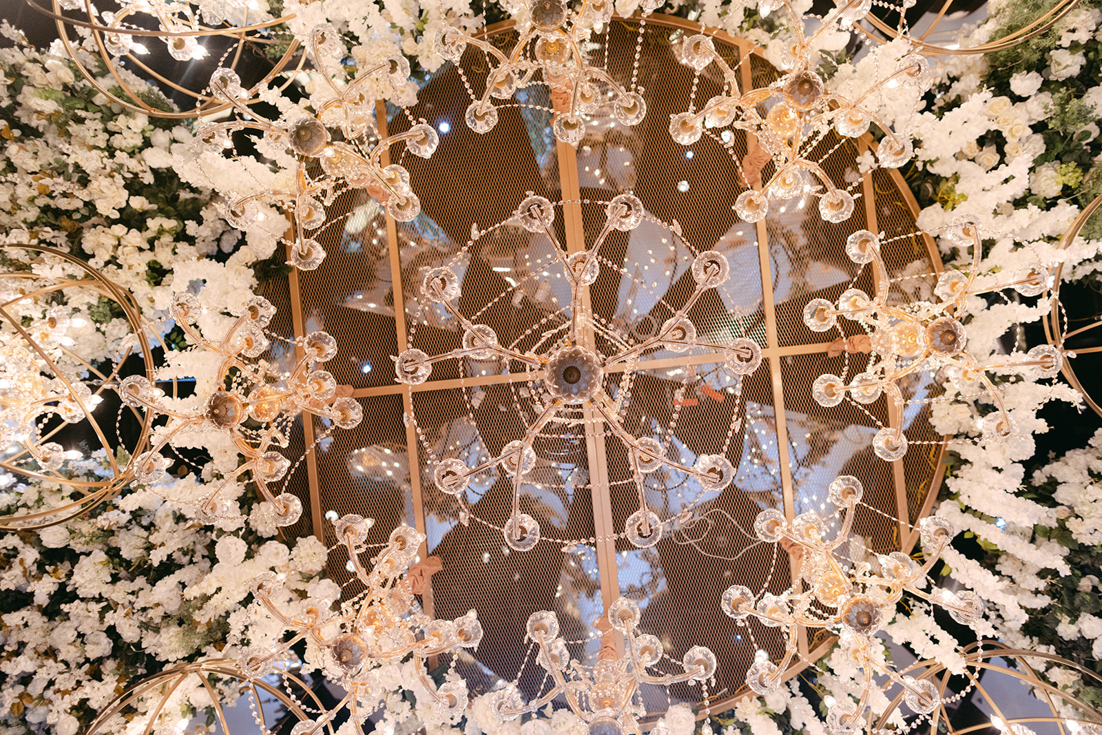 Having white florals with chandeliers over dance floor for Red Rock Casino Timeless Modern Wedding 