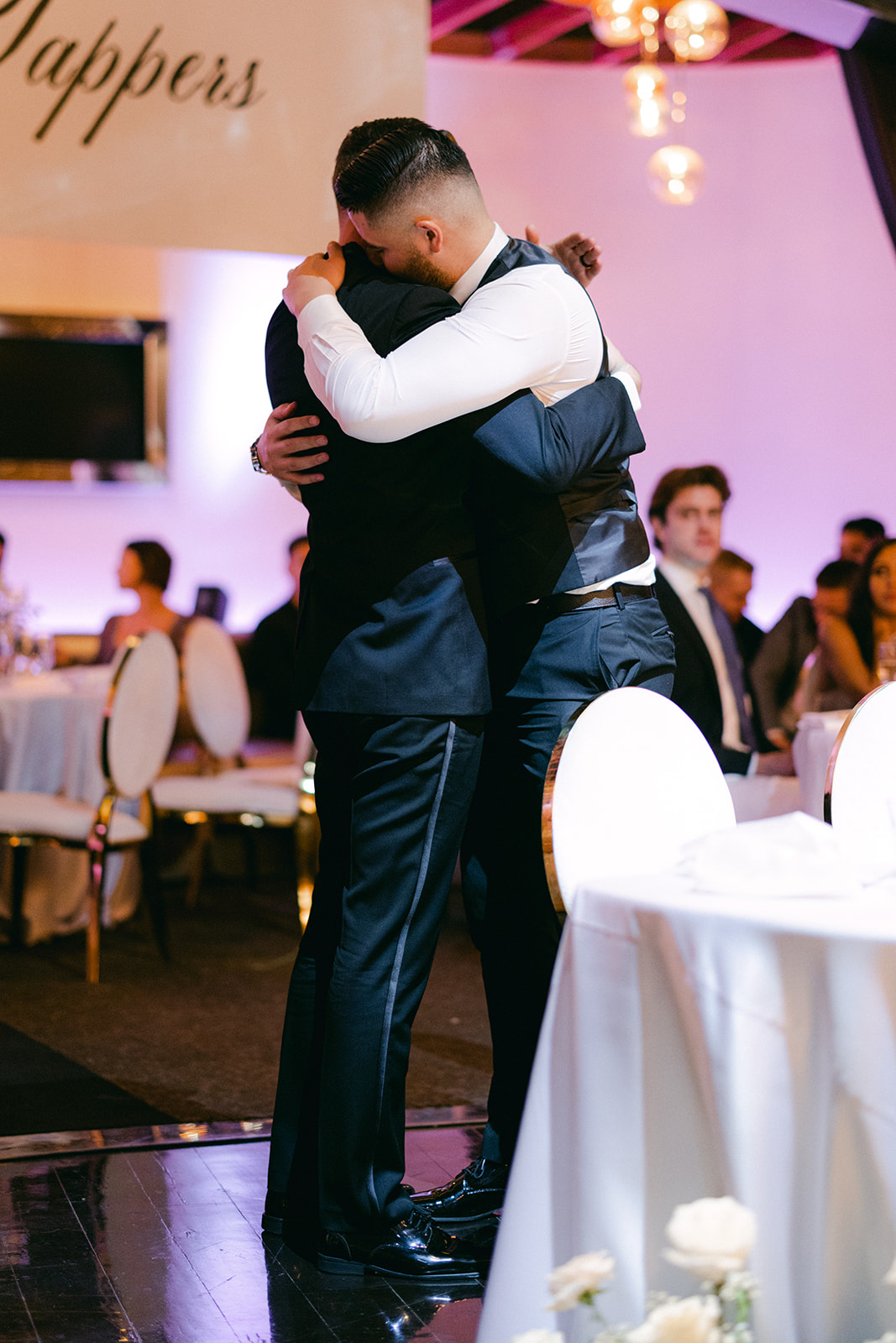 Groomsmen hugging groom during reception for Red Rock Casino Timeless Modern Wedding 