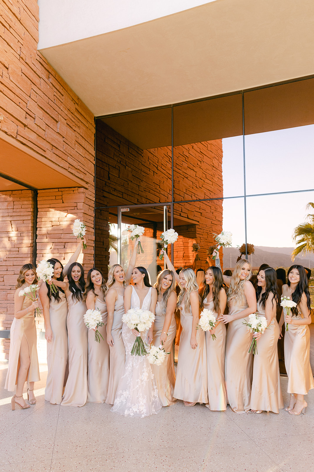 Wedding party with champagne bridesmaid dresses and white rose bouquets for Red Rock Casino Timeless Modern Wedding 