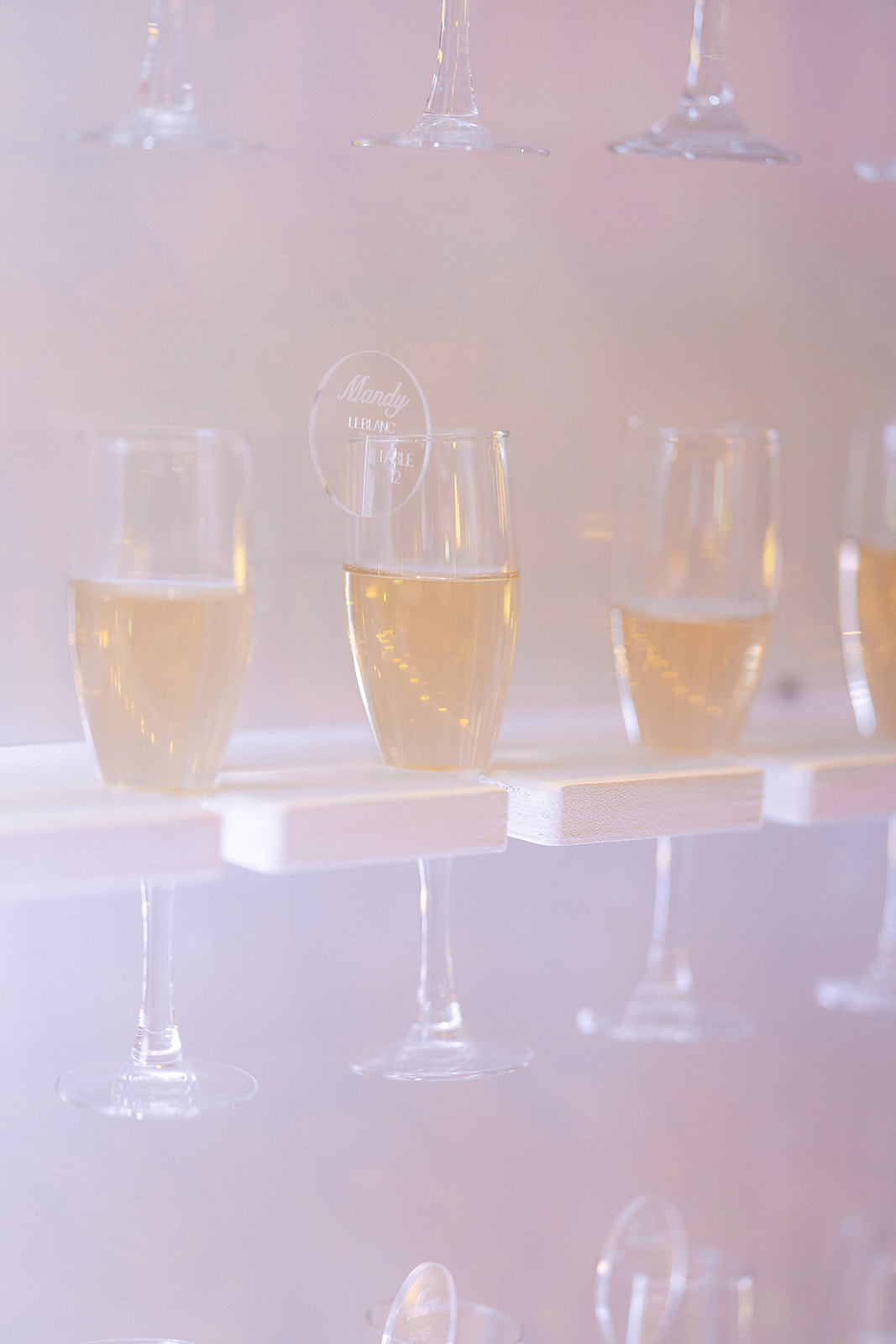 Champagne glasses held on champagne wall for cocktail hour 