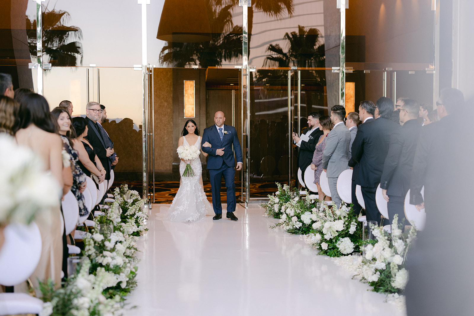 Bride walking down aisle with father 